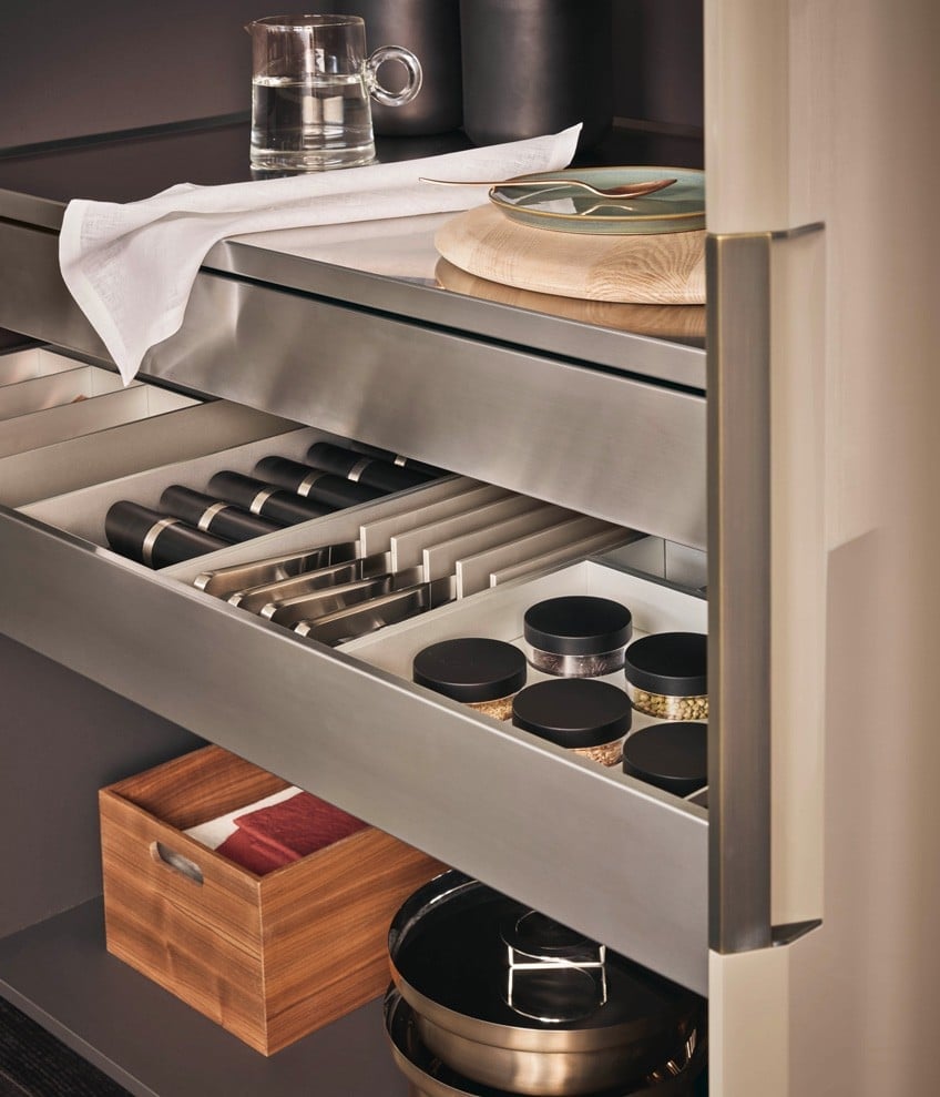 Stainless drawer interiors with knife storage, spice jars and walnut trays