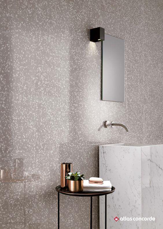 Terrazzo bathroom with copper fixtures