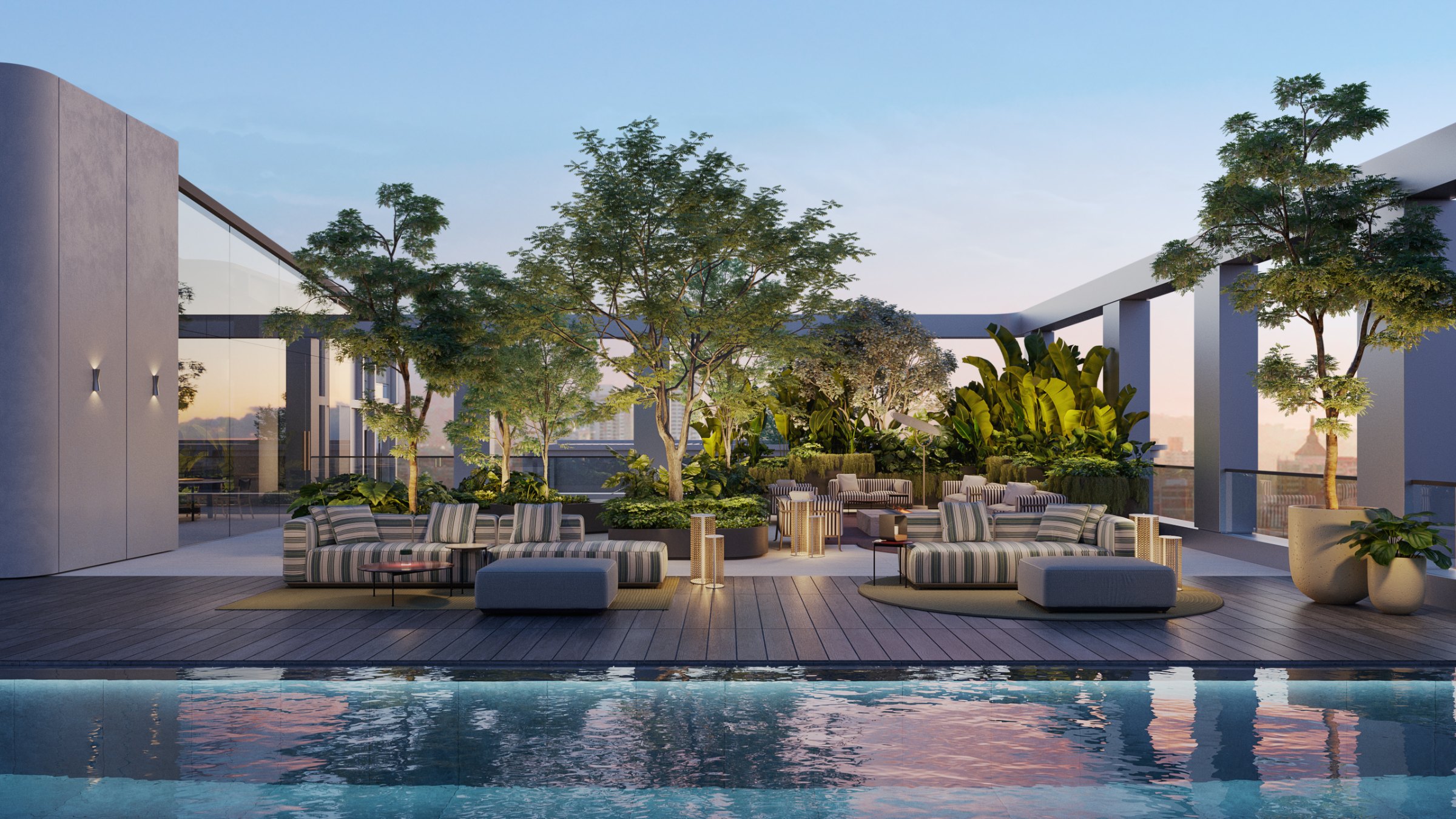 The private rooftop pool with planted garden and lounge at dusk